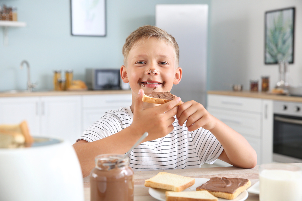 Funny,Little,Boy,Eating,Tasty,Toasts,With,Chocolate,Spreading,InFunny,Little,Boy,Eating,Tasty,Toasts,With,Chocolate,Spreading,In