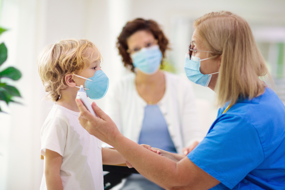 Pediatrician,Doctor,Examining,Sick,Child,In,Face,Mask.,Ill,Boy