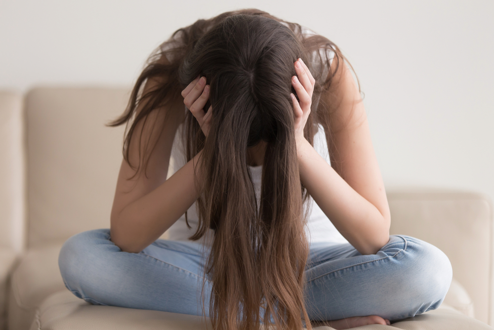 Depressed,Teenager,Sitting,Holding,Head,In,Hands,,Stressed,Sad,Young