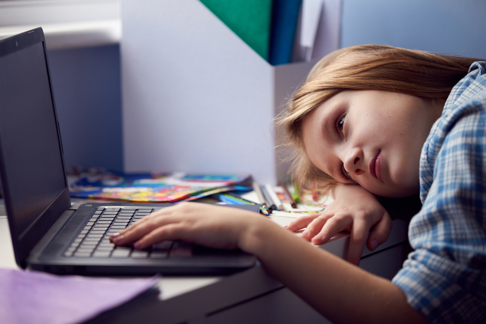 Bored,Girl,Sitting,Lying,Head,On,Desk,Whilst,Home-schooling,With