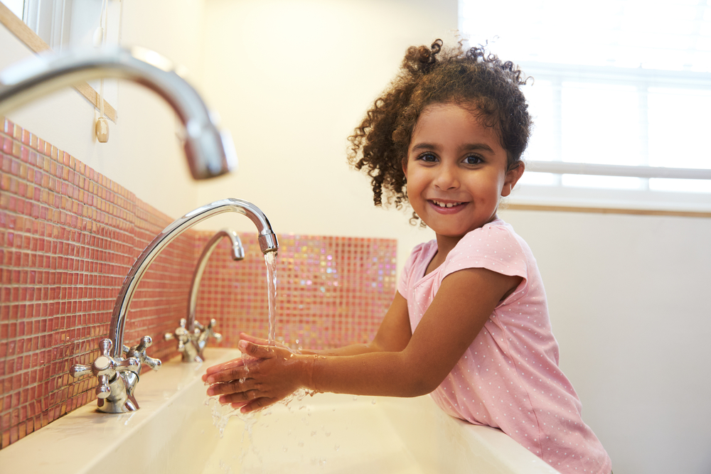 Female,Pupil,At,Montessori,School,Washing,Hands,In,Washroom