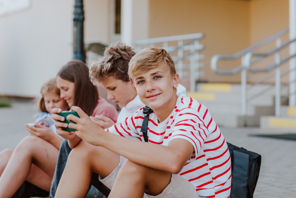 Cute,Teen,Boy,In,Casual,Clothes,Posing,With,Cell,Phone