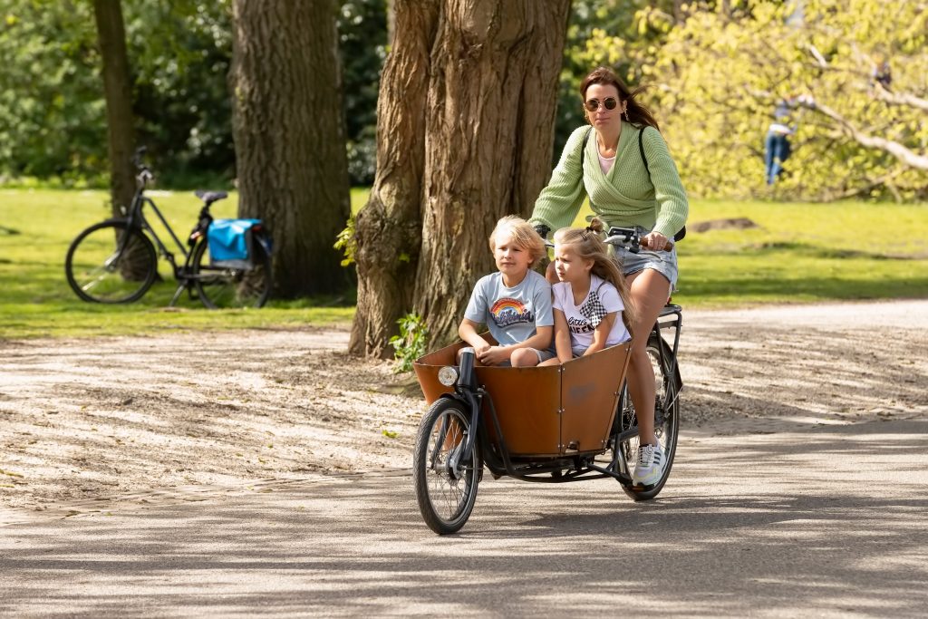 Amsterdam,,Netherlands,,April,18,,2022;,Young,Woman,Cycles,With,Her