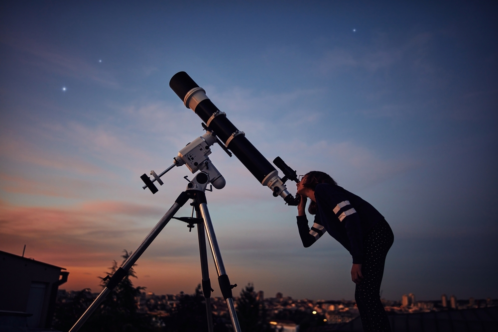 Girl,With,Astronomical,Telescope,Stargazing,Under,Twilight,Sky.