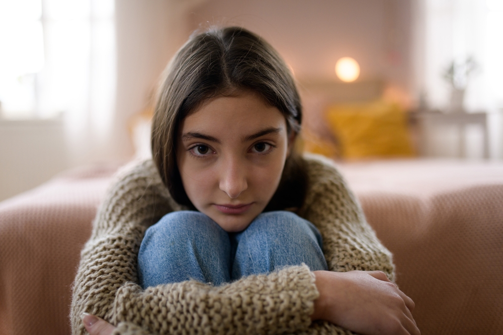 Teenage,Girl,Sitting,On,The,Floor,With,Head,On,Her