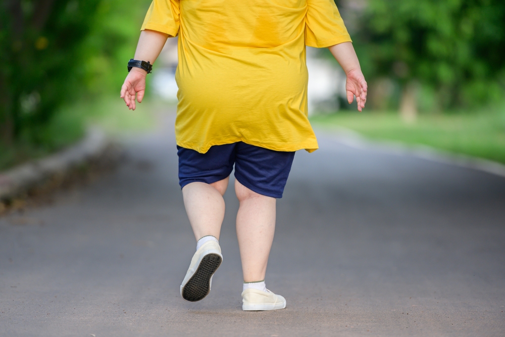 Back,View,Fat,Asian,Girl,Exercising,By,Walking,To,Burn