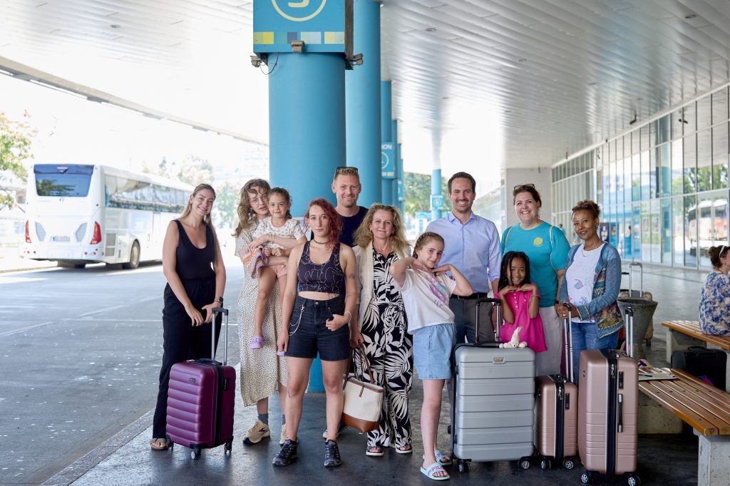 Vizebürgermeister Wiederkehr mit Familien am Vienna Bus Terminal beim Stadion Center.