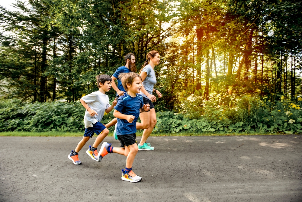 A,Family,Exercising,And,Jogging,Together,At,An,Outdoor,Park