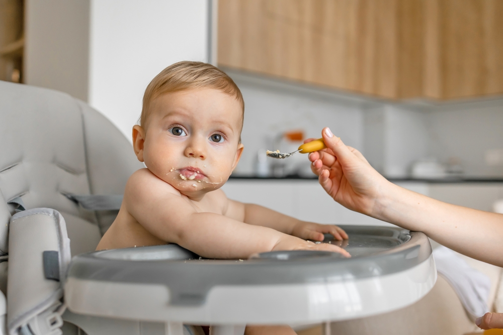 Mother,Hand,Feeding,A,Baby,From,A,Spoon.,Mom,Giving