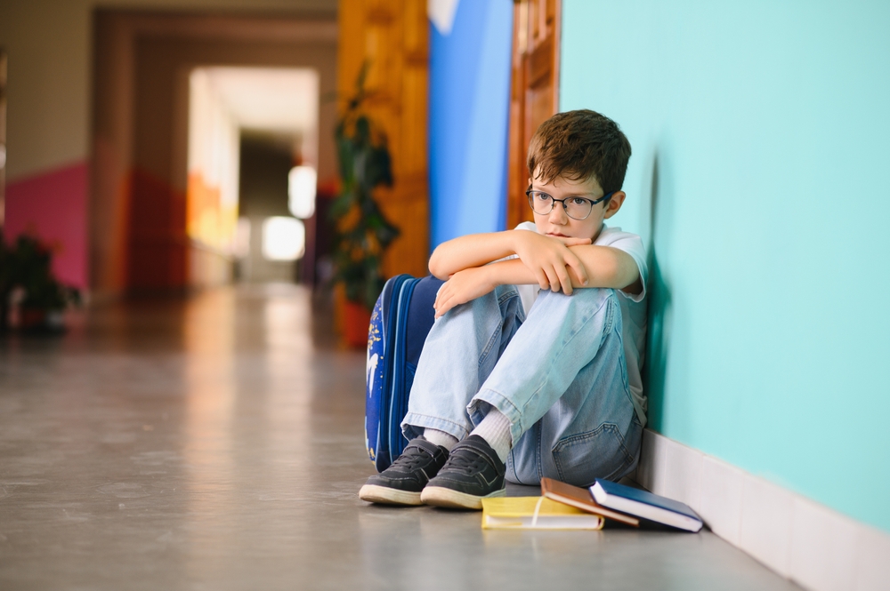 Young,Boy,Sitting,Alone,With,Sad,Feeling,At,School.,Bullying,