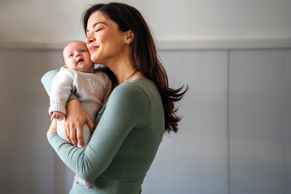 Loving,Mother,Carrying,Of,Her,Newborn,Baby,At,Home.,Family