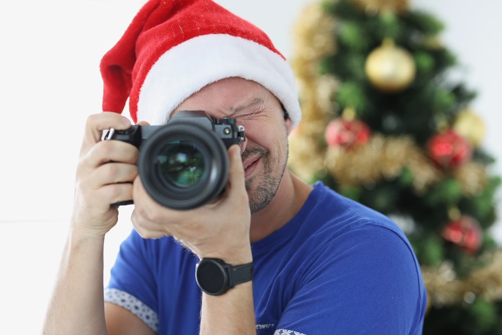 Man,In,Red,Santa,Hat,Taking,Pictures,With,Camera,Near