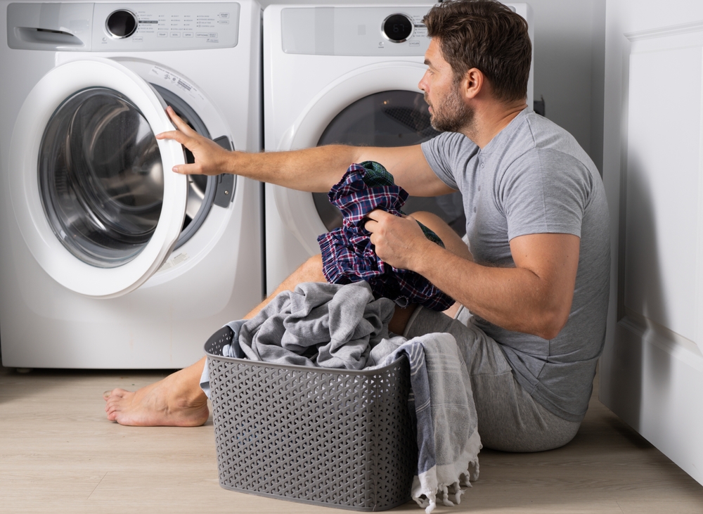 Portrait,Of,Sexy,Man,With,Dirty,Clothes,Near,Washing,Machine.