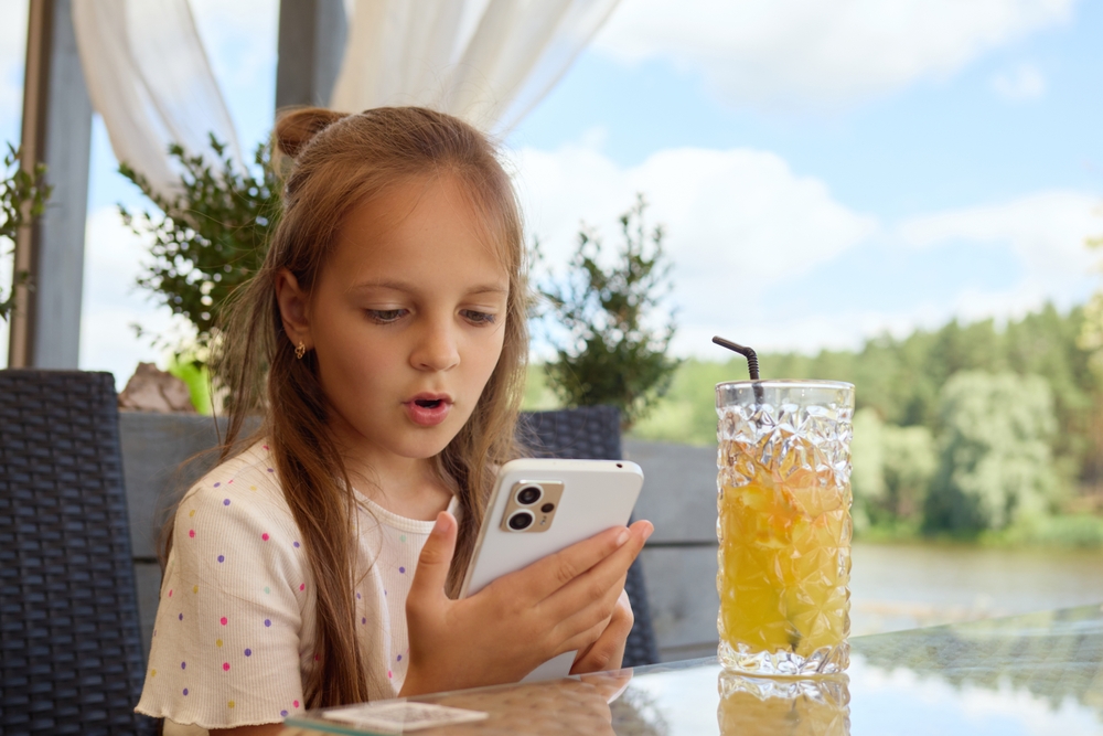 Brown-haired,Young,Girl,Sipping,On,Freshly,Squeezed,Orange,Juice,While