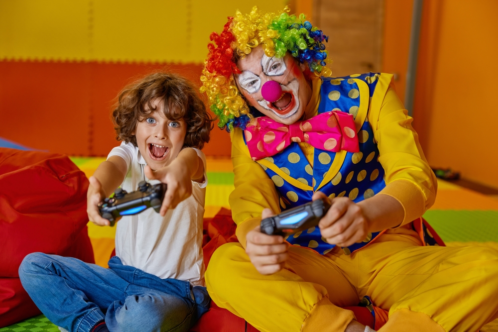 Portrait,Of,Little,Boy,Child,And,Funny,Clown,Playing,Video