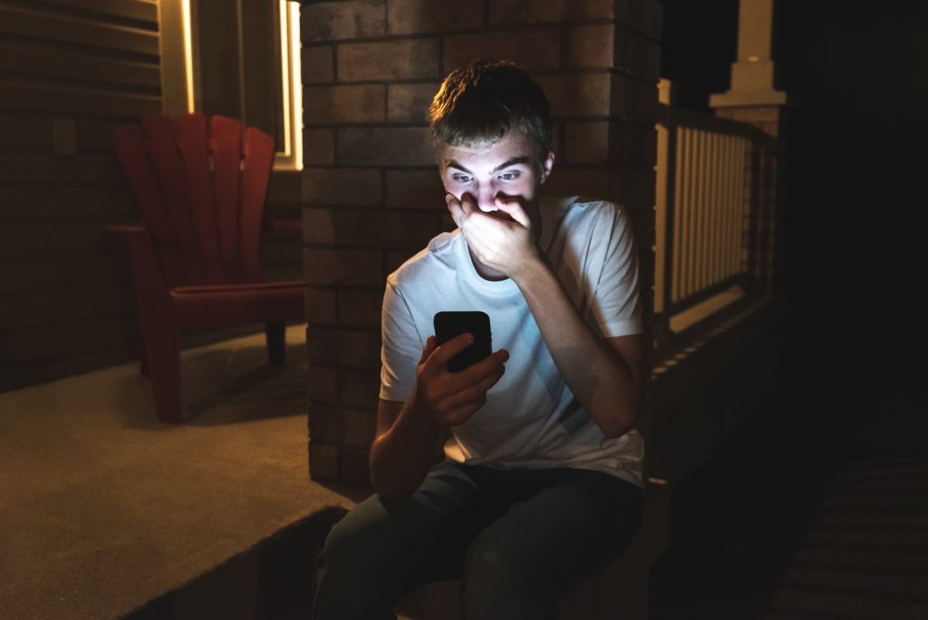 Teenager,Looking,At,Something,Shocking,On,His,Mobile,Phone.,He