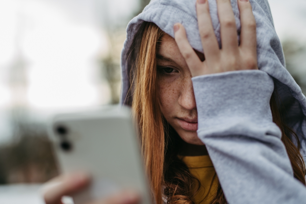 Portrait,Of,Teenage,Girl,Looking,At,Her,Smartphone,,Sad,,Anxious,