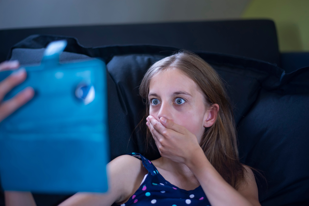 Afraid,Young,Girl,With,Smartphone